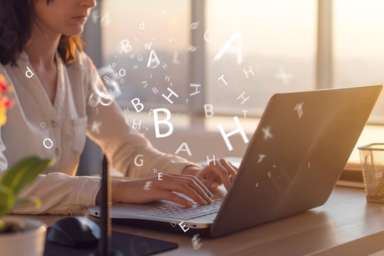 AI writing vs human writing comparison with AI-generated content and a human writer typing on a laptop.
