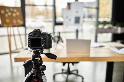Behind-the-scenes photo setup illustrating how to use video marketing with in-office video production.