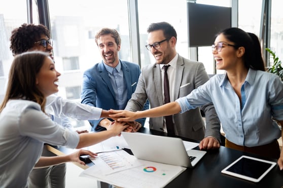 Business team celebrating a good job in the office.