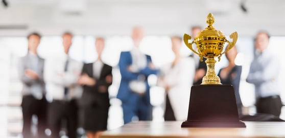 Business people celebrate for trophy
