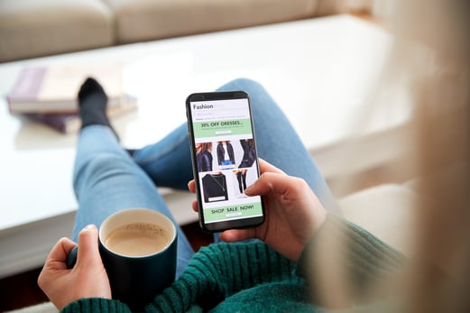 Customer shopping on a mobile device, showcasing the importance of mobile optimization as one of the best eCommerce tips.