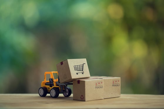 Fork-lift truck moves a pallet with Paper boxes.