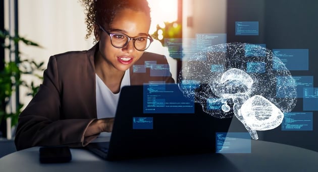 A business professional using a laptop, representing the role of AI in business. 