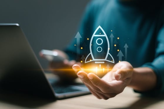 Businessman use laptop with virtual screen of rocket icon and up arrow for fast start up business.