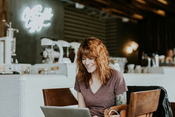 Tattooed woman with laptop.