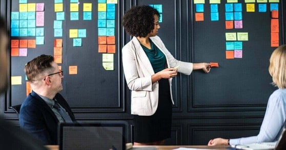 Team planning marketing strategy with sticky notes, representing in-house marketing vs agency decision-making.