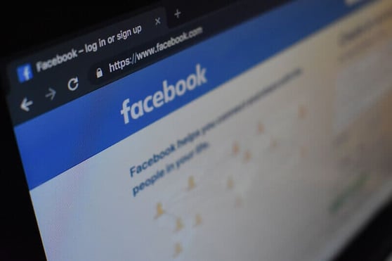 Close-up view of the Facebook login page on a computer screen, representing brand awareness services through social media. 